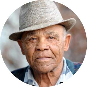 An elderly man wearing a hat