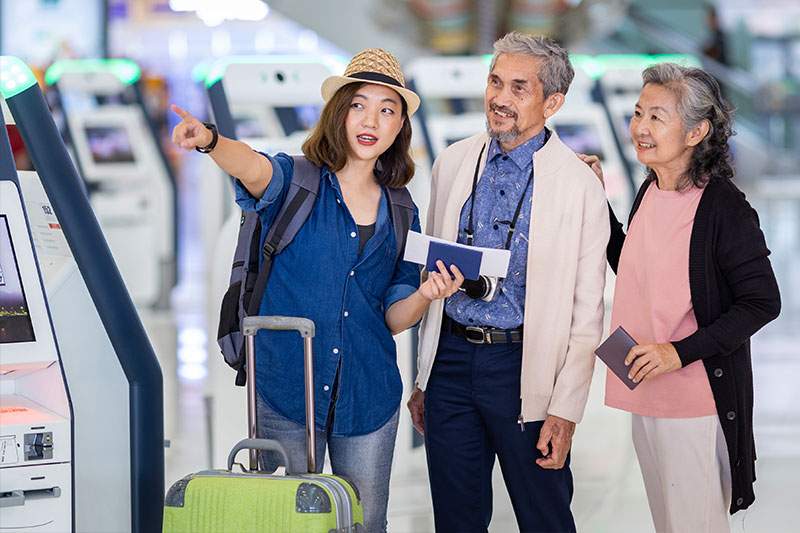 two seniors and a young woman at the airport