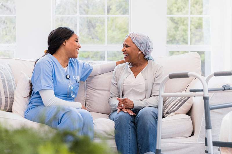 caregiver on the couch with female patient