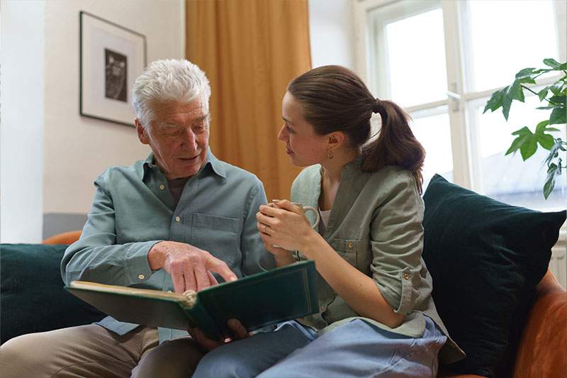 elderly man taking to a female aid